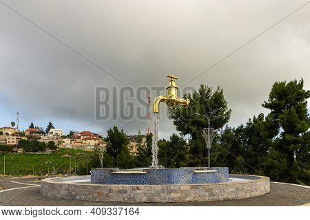 Zefat, Israel, February 13, 2021 : A Fountain In The Form Of A Faucet With Water Flowing Out Of It S