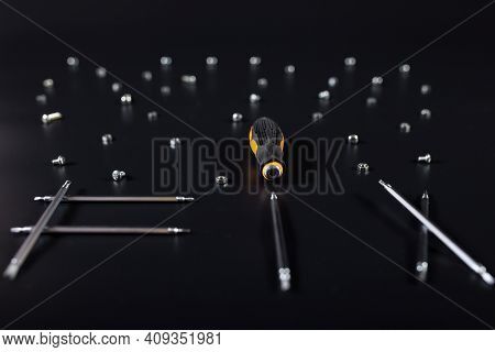Word Fix Made Of Metal Small Screwdriwers With Spare Parts On Black Background.