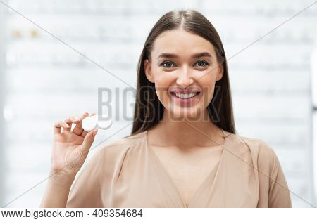 Vision Correction Concept. Portrait Of Smiling Lady Showing Plastic Container With Contact Eye Lense