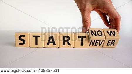 Start Now Or Never Symbol. Businessman Turns Wooden Cubes And Changes Words 'start Never' To 'start 