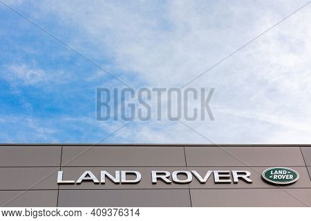 Land Rover Brand Logo On Bright Blue Sky Background Located On Its Dealer Office Building In Lyon, F