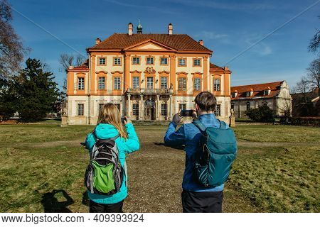 Tourists Backpackers Taking Pictures Of Old Abandoned Baroque Castle In Central Bohemia,czech Republ