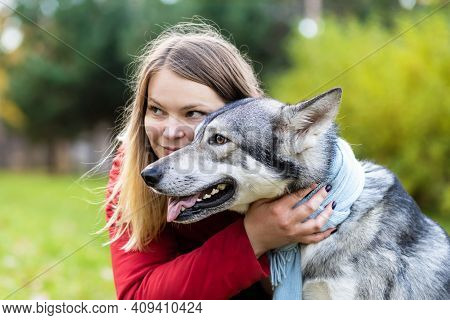 Young Happy Woman Hugging Dog. Pet Adoption.  Czechoslovak With Female Owner. Caucasian Girl Walking