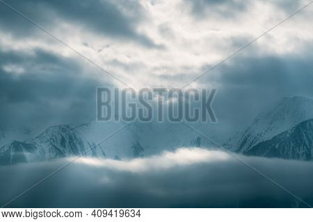 Mountains Covered With Snow Between Fog Clouds With Bright Sunrays Shining Through, Mieminger Platea