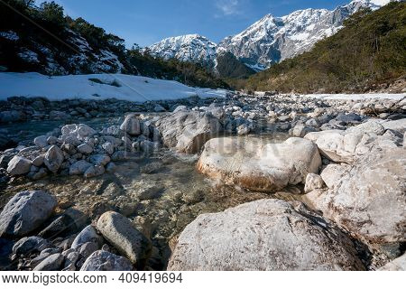 Rocky Clear Mountain River Flowing Through Evergreen Forest With Last Snow, Mieminger Plateau, Tirol