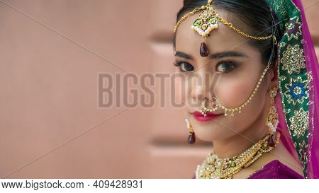 Portrait Asian Woman In A Margenta Indian Tradition Sari, She Is Looking At A Camera Next To The An 
