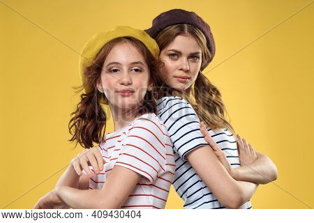 Cheerful Sisters In Hats Striped T-shirts Joy Lifestyle Yellow Background Family