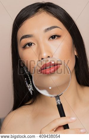 Concept Lip Augmentation Natural. Fashion Young Asian Woman Holding Magnifying Glass On Background O