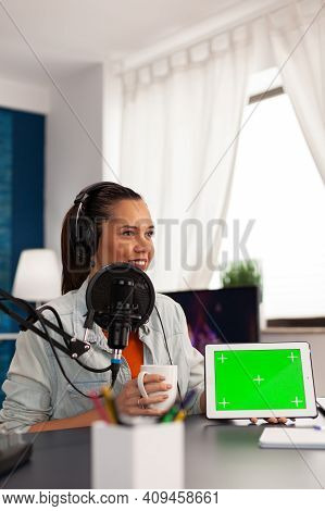 Famous Blogger Influencer Filming Video Of Tablet With Green Screen In Home Studio Podcast. Social M