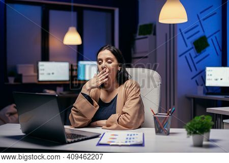 Sleepy Businesswoman Yawns While Working On Laptop Trying To Finish A Project Deadline. Smart Woman 