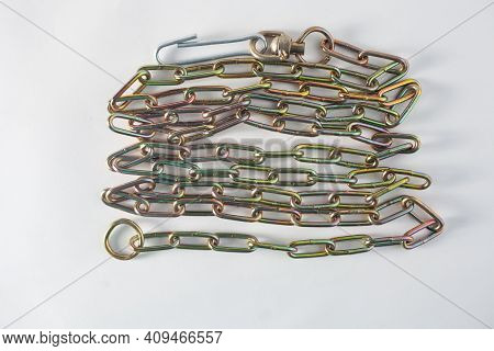 New Iron Chain For Dog Lies On White Background Like A Snake