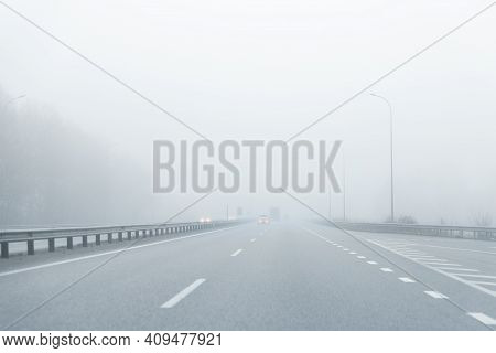 Driver Pov Of Almost Empty Grey Foggy Misty Rainy Highway Intercity Road With Low Poor Visibility On
