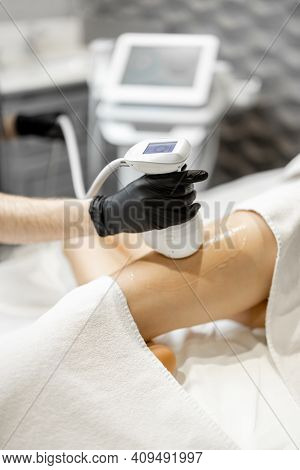 Doctor Doing Ultrasound Liposuction Procedure In Medical Clinic.