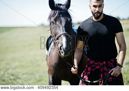 Arab Tall Beard Man Wear In Black With Arabian Horse.