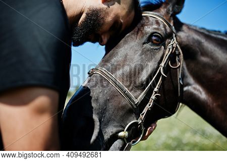 Arab Tall Beard Man Wear In Black With Arabian Horse.