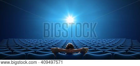 Cinema with one person sitting in 21:9 cinemascope format
