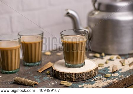 Masala Tea. A Cup Of Traditional Indian Tea Masala Tea With Ingredients To Prepare. Cinnamon, Anise,