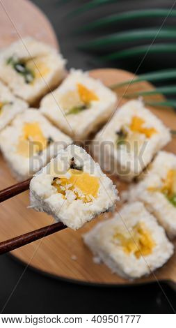 Dessert Sushi. Sweet Kiwi, Pineapple Sushi Rolls. Sushi On A Wooden Tray On A Black Background With 