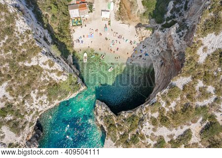 Aerial Overhead Drone Shot Of Tourists Swim Sunbath At Stiniva Beach On Vis Island In Croatia Summer