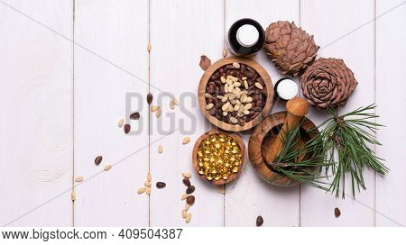 Cedar Oil, Branches And Cedar Cone On White. Copy Space. Beauty And Healthy Concept. Energizing Faci
