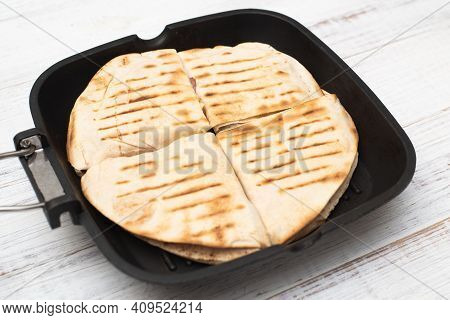 Tortilla With Cheese And Ham. Pita With Grated Cheese, Ham, Tomatoes On A Grill Pan.