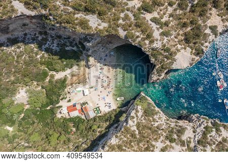 Aerial Overhead Drone Shot Of Tourists Swim Sunbath At Stiniva Beach On Vis Island In Croatia Summer