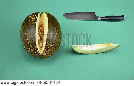 Melon, A Piece Of Melon Already Cut And A Knife