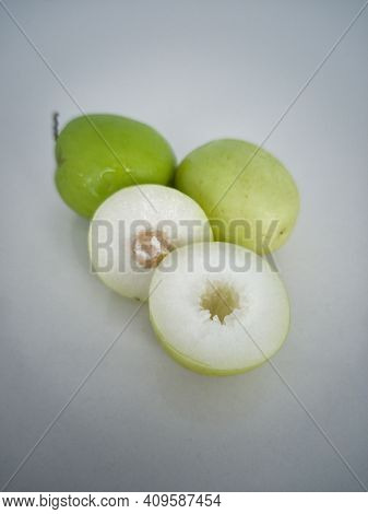 Indian Jujube Fruit Or Ziziphus Mauritiana Or Buah Bidara In A Rattan Bowl. Blurred Background