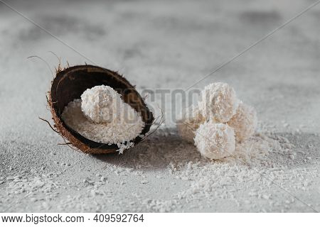 Coconut Healthy Sugarfree Balls In Coconut Shells With Coco Flakes On Light Gray White Background