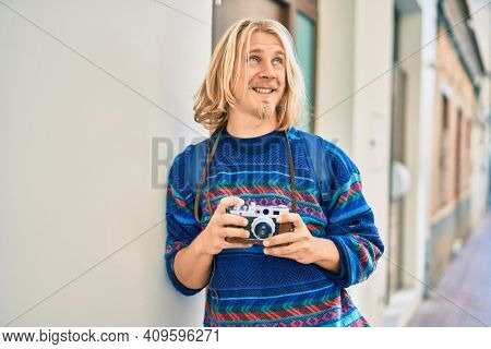 Young scandinavian tourist man smiling happy at the city.