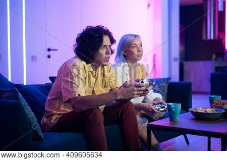Handsome Young Man Teaching How To Play The Video Games To His Girlfriend, On The Couch, Concept Abo