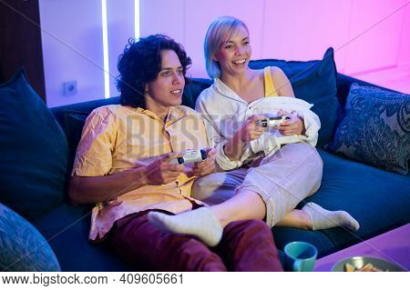 Handsome Young Man Teaching How To Play The Video Games To His Girlfriend, On The Couch, Concept Abo