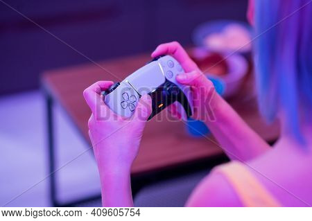 Girl With Next Gen Controller In Her Hands Playing Games At Home.