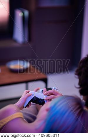 Girl With Next Gen Controller In Her Hands Playing Games At Home.