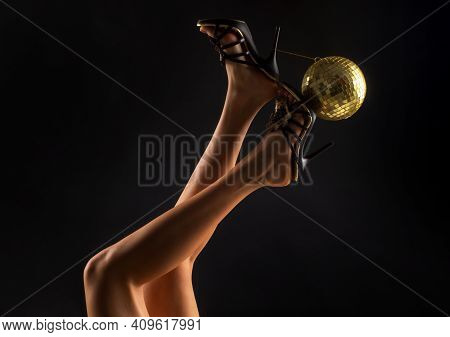 Party Time. Disco Legs. Celebrate Concept. Heels With Gold Ball
