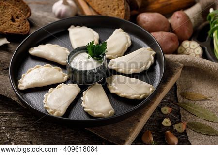 Appetizing Traditional Russian Dumplings, Hand-made With Potatoes. Still Life On A Wooden Board. Clo