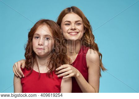Family Mom And Daughter Hug Red Dresses Communication Emotions Blue Background