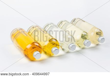Collection Transparent Lying Bottles With Different Pale Colors Liquid, Cosmetic Product, Perfume Or