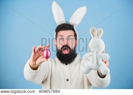 Funny Bunny With Beard And Mustache Hold Pink Egg. Easter Symbol Concept. Bearded Man Wear Bunny Ear