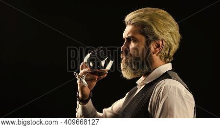 Wine Bar Or Winery. Wine Degustation. Bearded Businessman In Elegant Suit With Glass Of Wine. Sommel