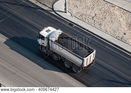 Truck With A Breakstone On A Road In The City During Road Construction Work.