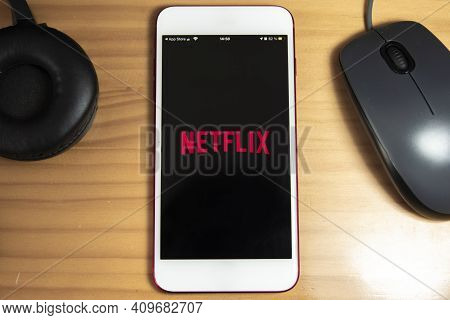 Spain, 02, 24, 2021: Apple Smartphone With Netflix Application Start Screen In A Table