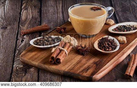 Masala Tea. Flavoured Tea Chai. Traditional Indian Hot Drink With Various On A Wooden Board In A Por