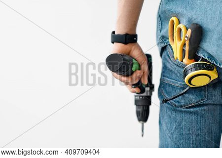 Tool For Drilling, Fixing And Professional Builder, Repairman. Millennial Man Hold Electric Drill In