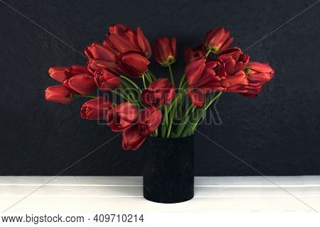 Blood Red Tulips On A Dark Background. Wooden White Table Made Of Boards.