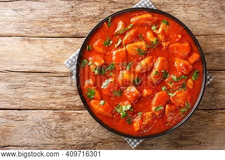 Romanian Ostropel Chicken With Garlicky Tomato Gravy Closeup In The Plate On The Table. Horizontal T