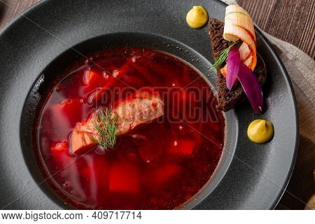 Ukrainian Traditional Borshch. Beetroot And Cabbage Soup With Meat. Macro Close-up Of The Dish In Bl
