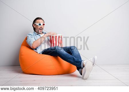 Full Length Photo Of Handsome Man Sit Chair Wear 3d Glasses Eat Popcorn Watch Film Isolated Over Gre
