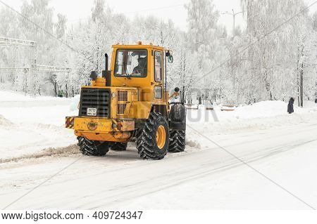 Agidel, Russia Republic Of Bashkortostan - February 04, 2021: Big Yellow Tractor Cleans Snow On City