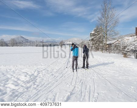 Czech Republic, Cvikov, January 25, 2021: Man And Woman Skiers At Start Of Ski Run Trail At Winter F